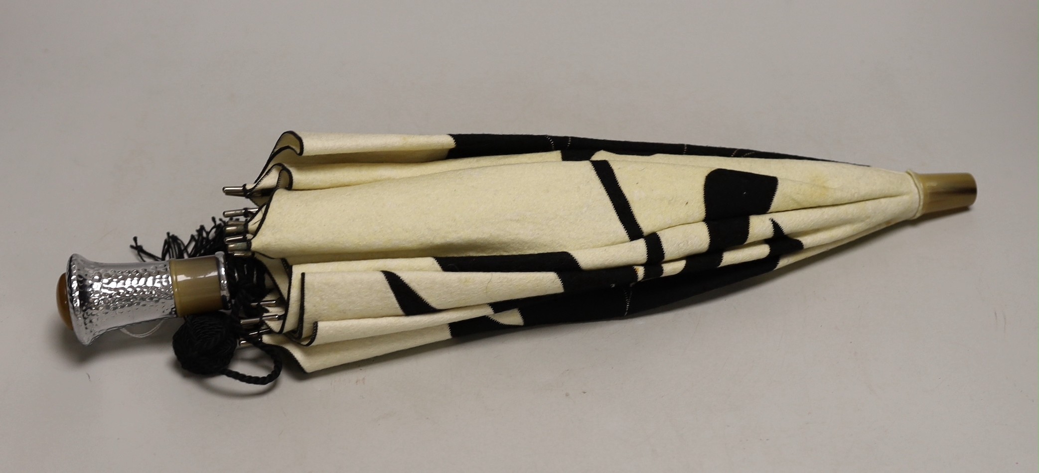 An unusual Japanese designed Art Deco cream and black felt parasol, with a horn and hammered metal handle